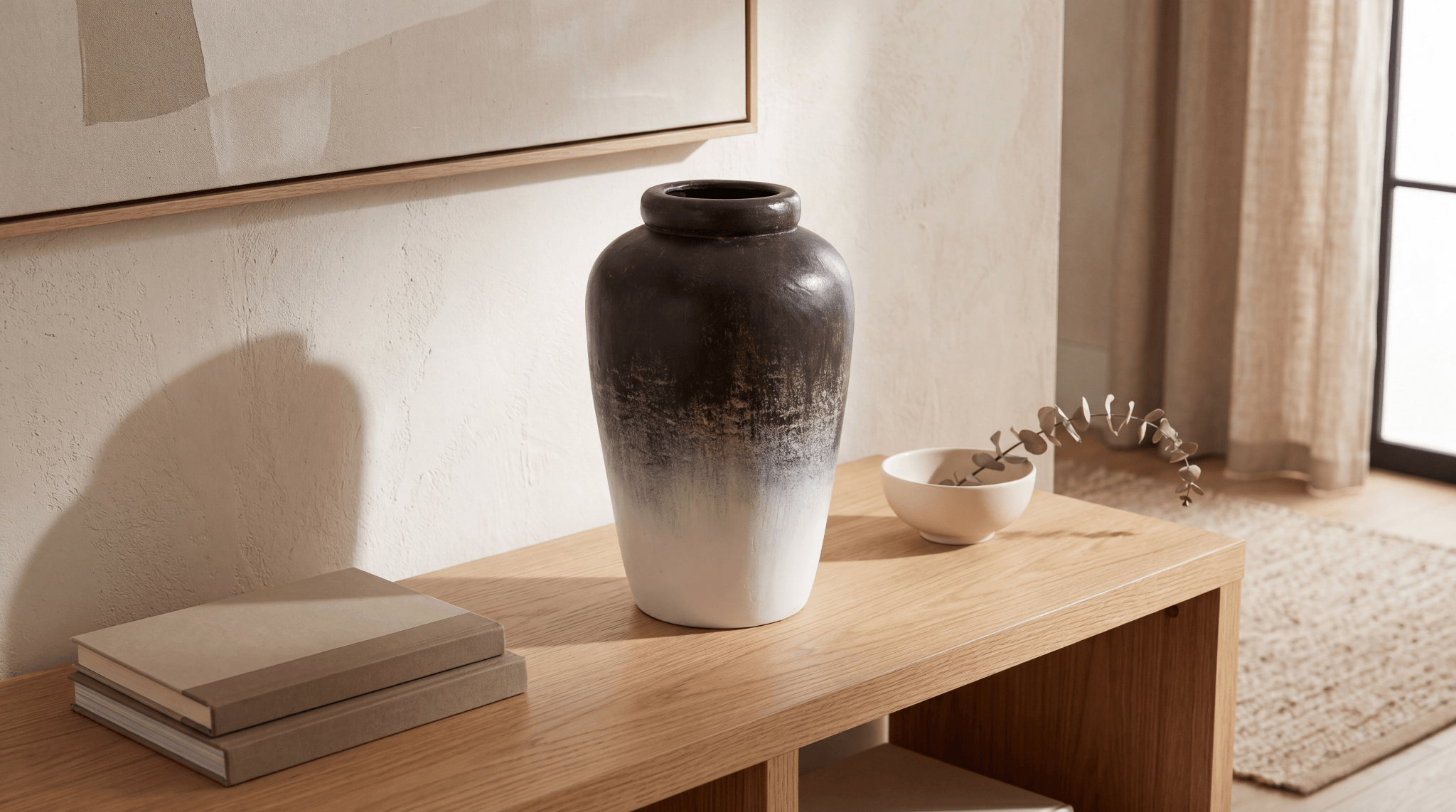 Black-and-white ombre ceramic vase for home decor styled on a wood console with abstract wall art